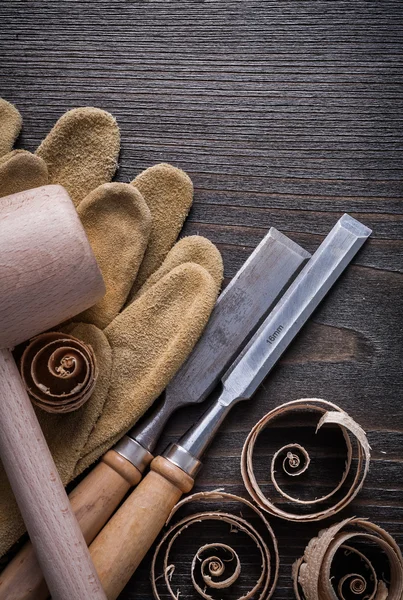 gloves, flat chisels, wooden mallet