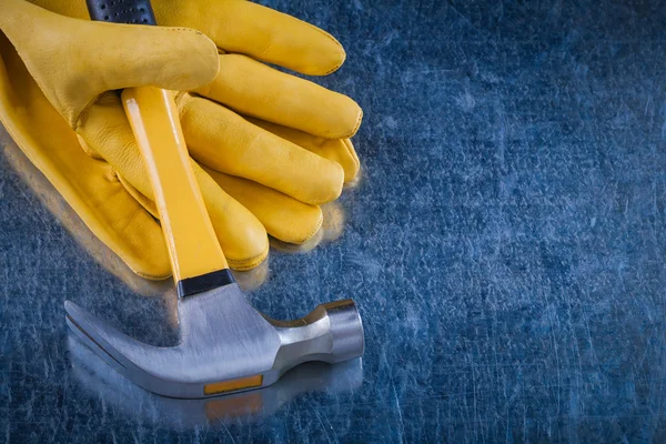 Leather gloves with claw hammer — Stockfoto