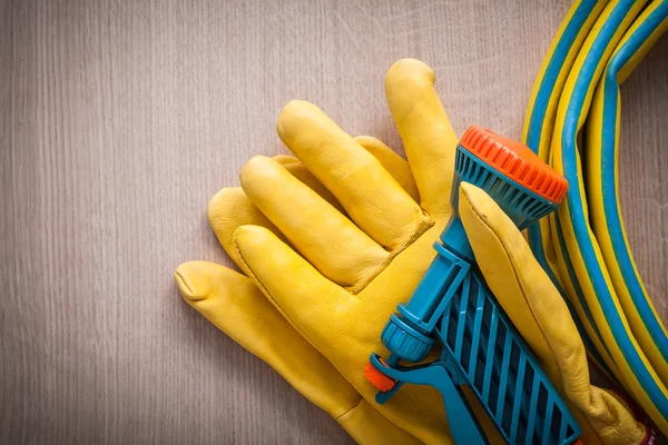 Leather gardening working safety glove and hand spraying hose wi — Stock Photo, Image