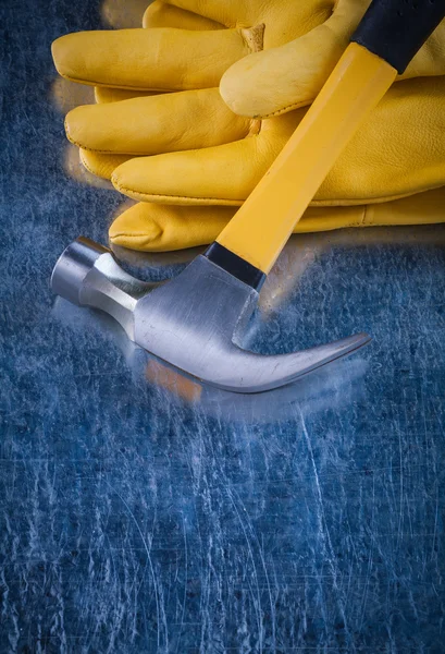 Leather protective gloves with claw hammer — Stock Photo, Image