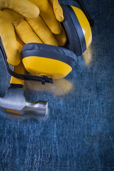 ear muffs, hammer and leather gloves