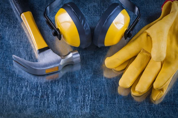 Ear muffs, hammer and leather gloves — Stock Photo, Image