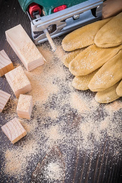 Electric jigsaw sawdust, leather gloves — Stock Photo, Image