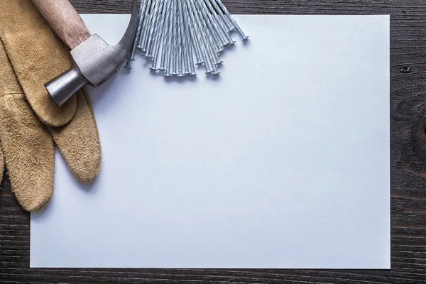 Sheet of paper, stainless nails, hammer — Zdjęcie stockowe