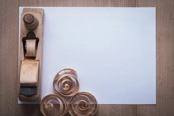 Wooden planer and sheet of paper — Stock Photo, Image