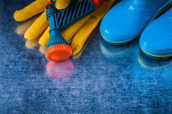 Rubber boots, gloves and garden hose — Stock Photo, Image