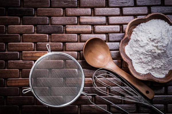 Spoon, bowl with flour, egg whisk — Stock Photo, Image