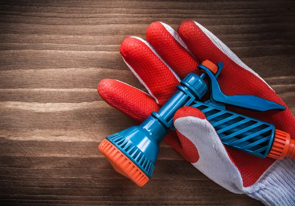 Working glove and water hose nozzle — Stock Photo, Image