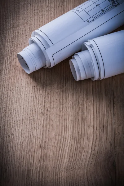 Blueprint rolls on wooden board — Stock Photo, Image