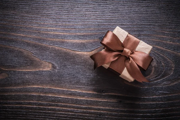 Giftbox on vintage wooden board — Stock Photo, Image