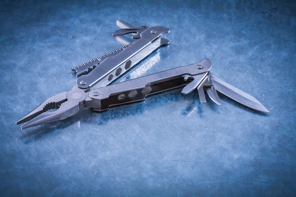 Multipurpose steel clasp-knife on metallic surface — Stock Photo, Image