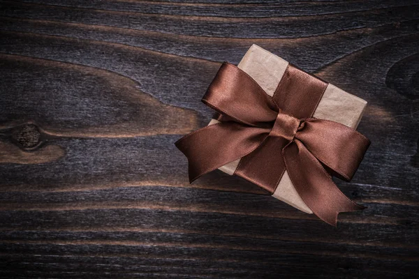 Present box with brown ribbon — Stock Photo, Image