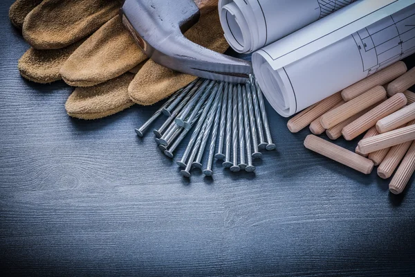 Dowels hammer blueprints nails gloves — Stock Photo, Image