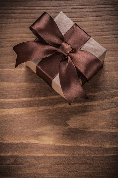 Packed present on vintage wood board — Stock Photo, Image
