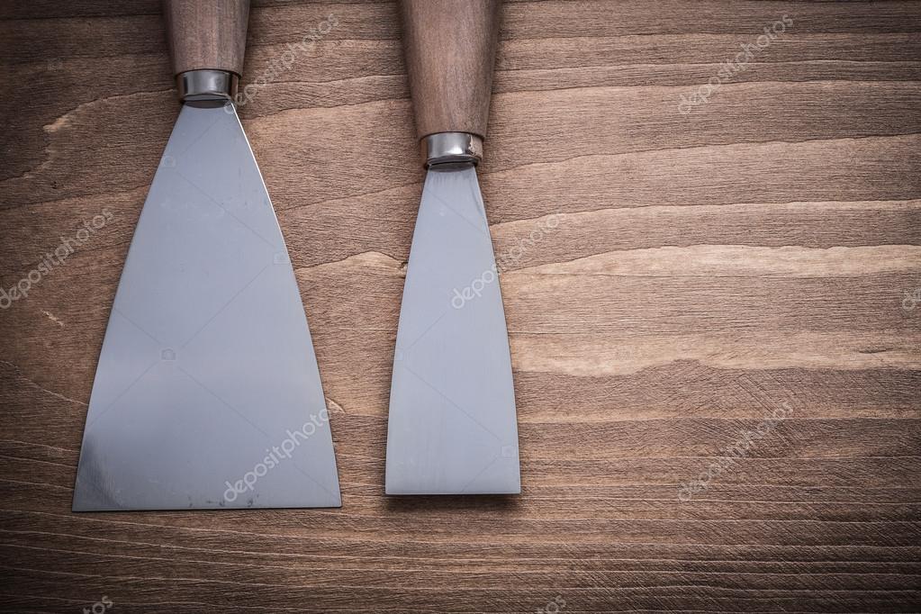 Paint scrapers on wood board — Stock Photo © mihalec 82988810