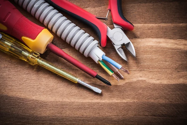 Insulated screwdrivers and corrugated pipe — Stock Photo, Image