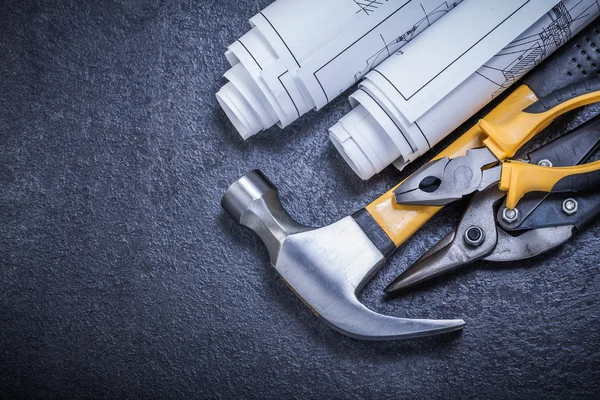 Rolled blueprints and claw hammer — Stock Photo, Image