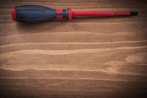 Insulated turnscrew on wooden board — Stock Photo, Image