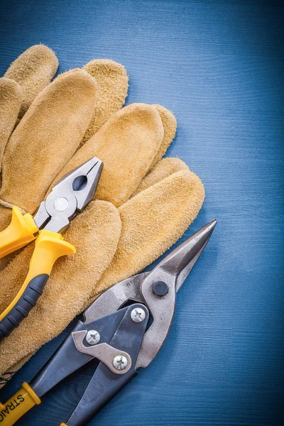 Pliers steel cutter and leather gloves — Stock Photo, Image