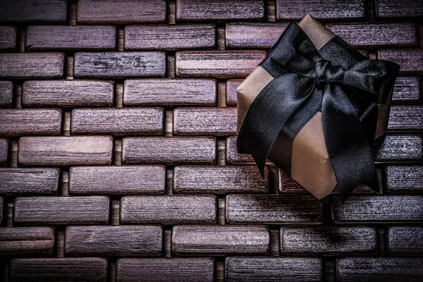 Present box with black ribbon