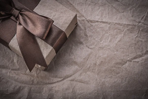 Gift box on wrapping paper — Stock Photo, Image