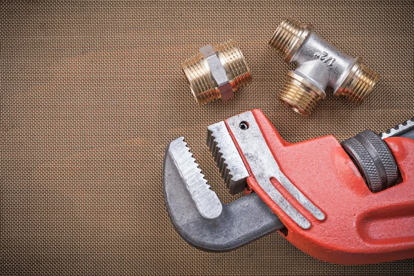 Adjustable wrench and brass connector fittings — Stock Photo, Image