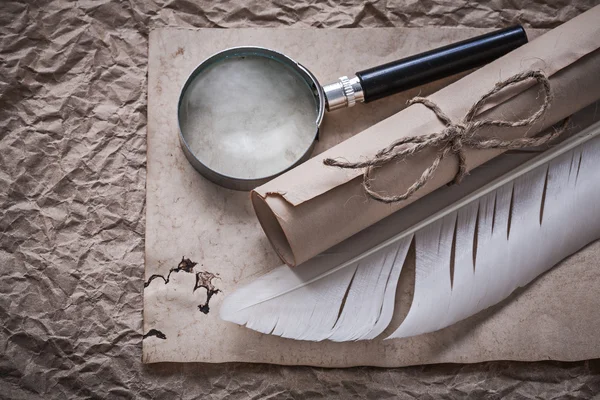 Vintage feather, magnifier, rolled document — Stock Photo, Image