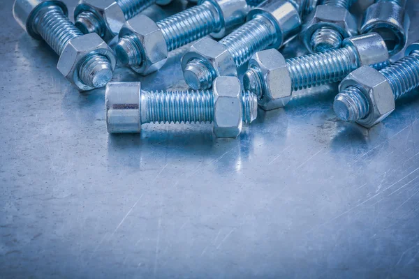 Bolts and nuts on metallic surface — Stock Photo, Image