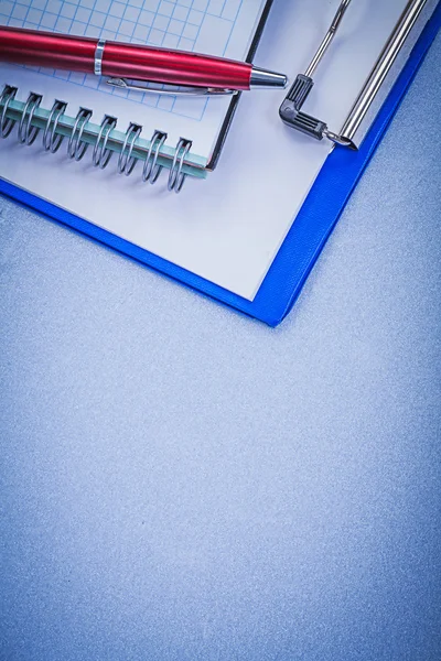 Red pen, checked copybook and notepad — Stock Photo, Image