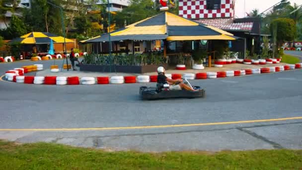 PHUKET. THAILAND - CIRCA FEB 2015: Tourist rushes around a turn in a go-cart at Patong Go-Kart Speedway in Kathu. Phuket. Thailand. — Stock Video