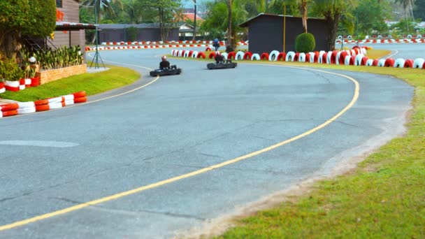 PHUKET. THAILAND - CIRCA FEB 2015: People rushes around a turn in a go-cart at Patong Go-Kart Speedway in Kathu. Phuket. Thailand. — Stock Video