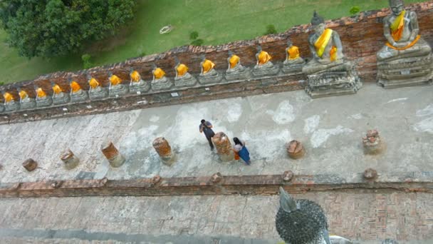 Ayutthaya. Tayland - Circa Feb 2015: Ayutthaya'daki Wat Yai Chai Mongkhon'daki Antik Tapınak Avlusında Buda Heykellerinin Eşsiz Eğimli Görünümü. Tayland. — Stok video