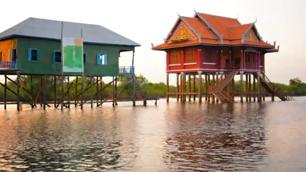 洞里萨湖。柬埔寨 - Circa 2013 年 12 月：一座佛教寺庙矗立在直接沉入河底的高跷上。其高架位置保护它免受季节性洪水的破坏. — 图库视频影像