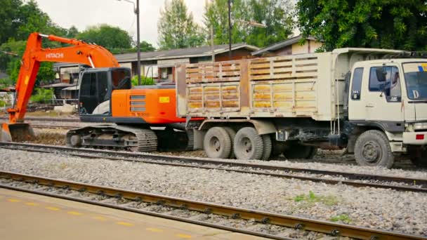 LOPBURI. THAILAND - CIRCA NOV 2013: Heavy equipment digging into rail bed on a railway line at Lopburi Station in Thailand. with sound. — Stock Video