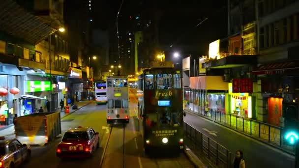 Riding a trolley along a downtown. urban street in Hong Kong. China at night. — Stock Video