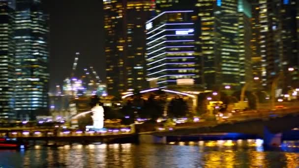 Beautifully lit modern commercial towers in downtown Singapore's business district at night. — Stock Video