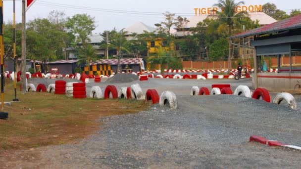 PHUKET. THAILAND - CIRCA FEB 2015: Tourists cruising around a rough. gravel track at Patong Go-Kart Speedway in Kathu. Phuket. Thailand. — Stock Video