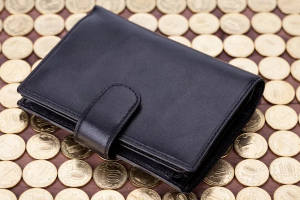 Black leather wallet on golden coins — Stock Photo, Image