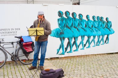 Unedentified musician playing music on the Berlin street clipart