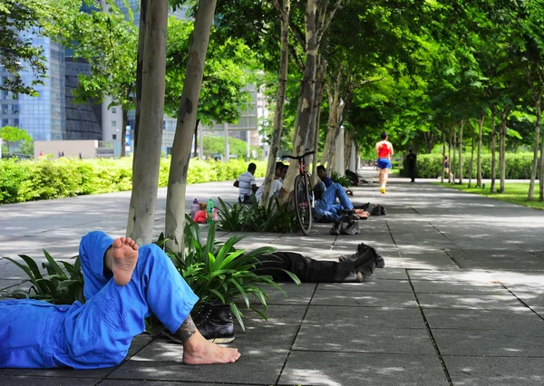 People lying in park — Stock Photo, Image
