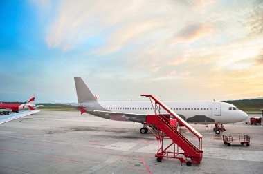 Airplaines at airport at sunrise clipart