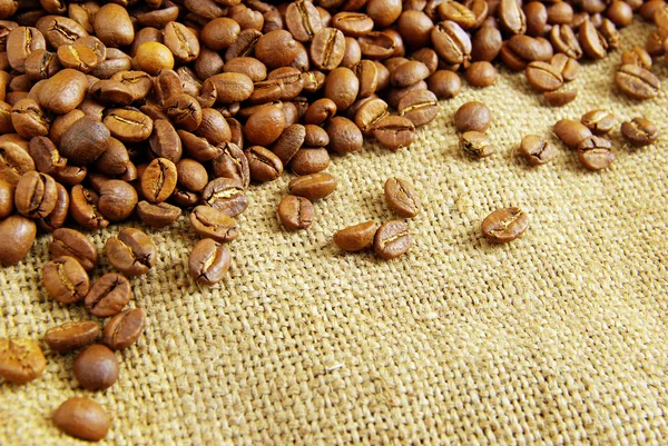 Coffee beans on burlap — Stock Photo, Image