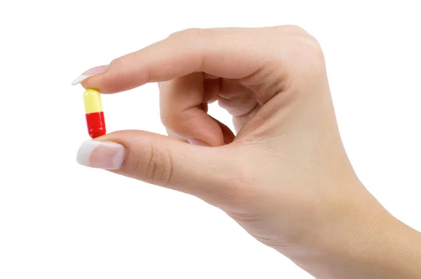 Hand holds pill — Stock Photo, Image