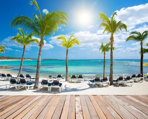 Mesa de madera superior en fondo de playa de arena blanca y mar azul