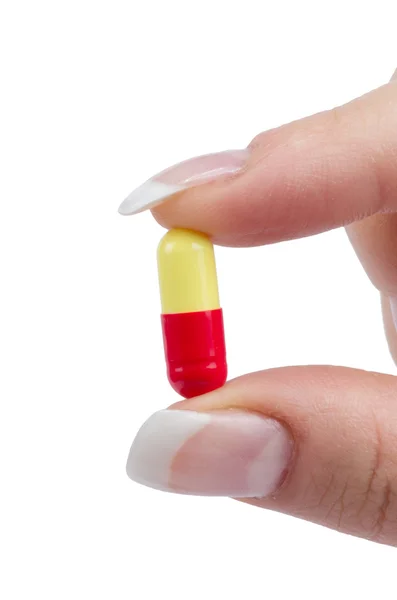 Female hand holds pill — Stock Photo, Image