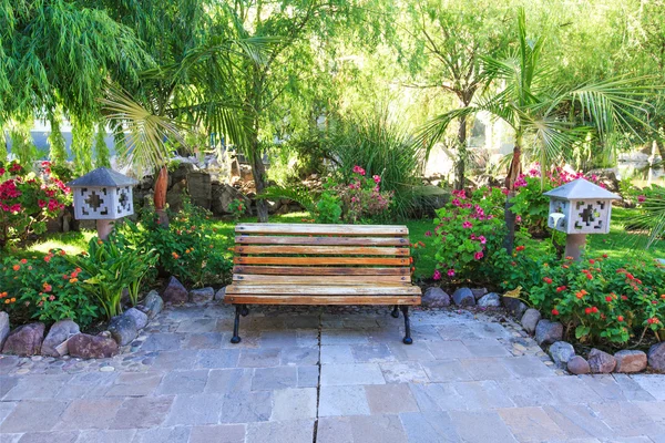 Garden landscape with bench — Stock Photo, Image