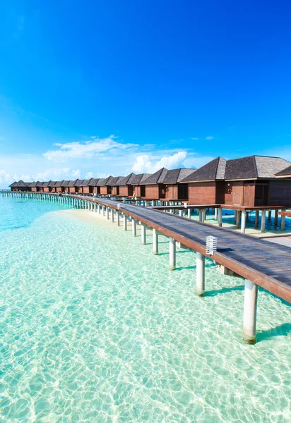 Beach with water bungalows and blue lagoon — Stock Photo, Image