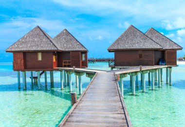 beach with water bungalows clipart