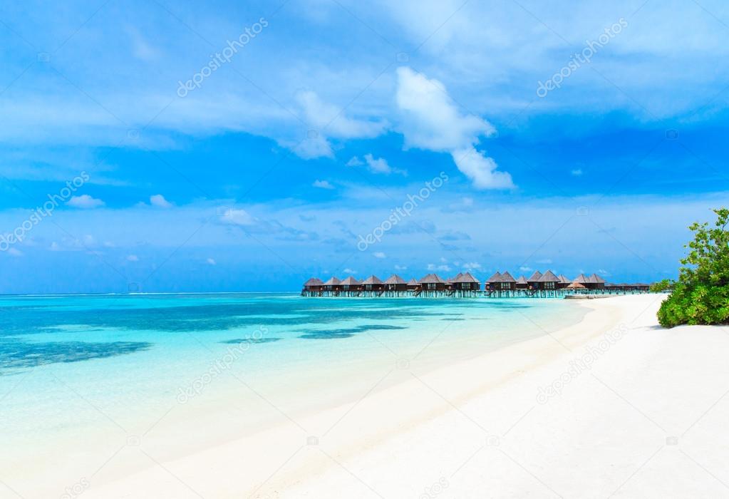 Beach with blue lagoon and bungalows