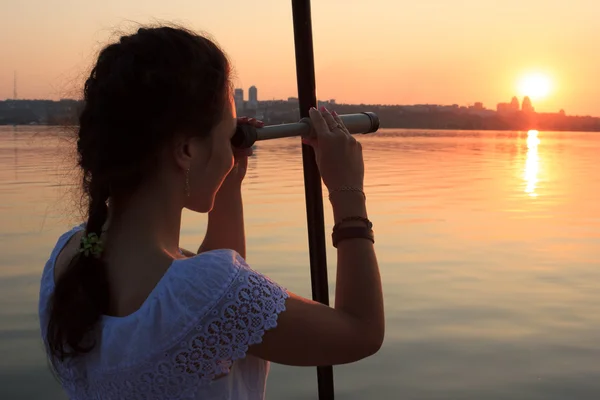 Girl watching spyglass — Stock Photo, Image